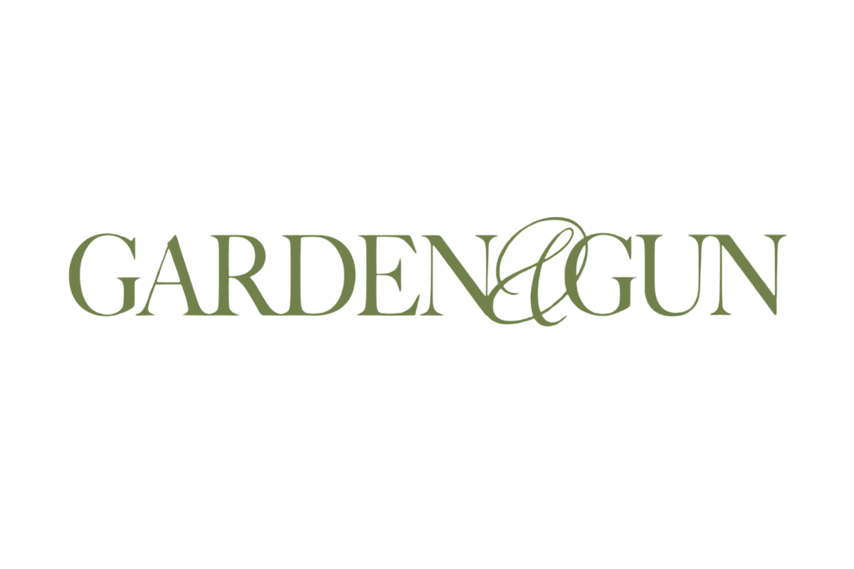 The logo for Garden & Gun, featuring the brand name in a muted sage green serif typeface with an elegant ampersand, centered on a plain white background.